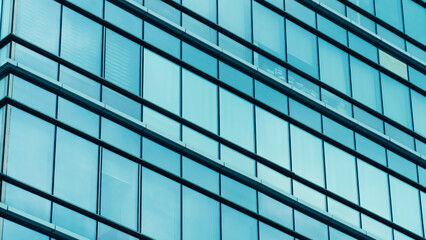 Fototapeta na wymiar Skyscraper glass facade. Office exterior. Details of complex high rise building. Financial district. Glass facade building Tech industry