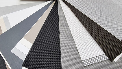 samples of roller blind fabrics in different textures and colors, close up view. roman curtain...