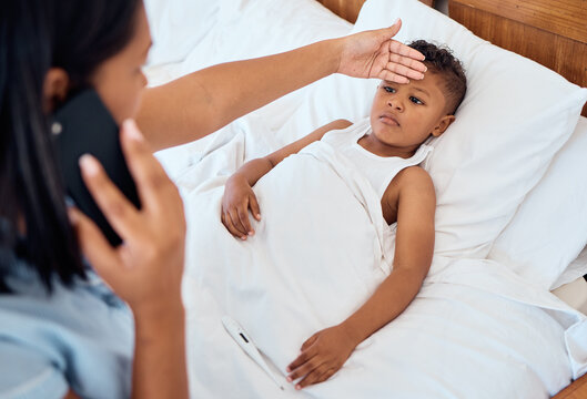 Phone call, healthcare and mother with child in bedroom check for fever for virus, first aid and care. Worry, medical and sick with mom hand on kid forehead in family home for flu, illness or disease