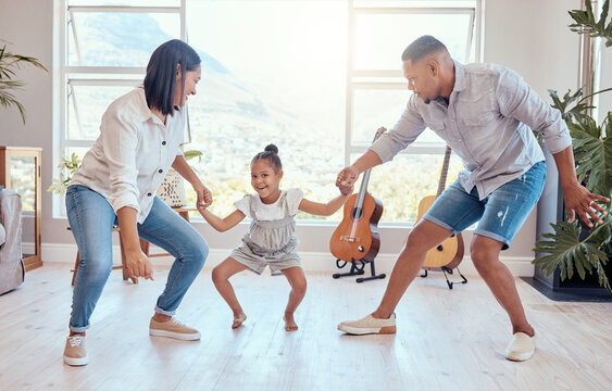 Family, dance and child with mom and dad having fun, bonding and enjoying weekend. Movement, love and young girl dancing with mother and father in living room for wellness, joy and happiness in home