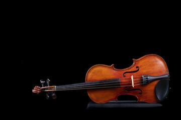 Fototapeta na wymiar Violin on Side in Color with dark background 