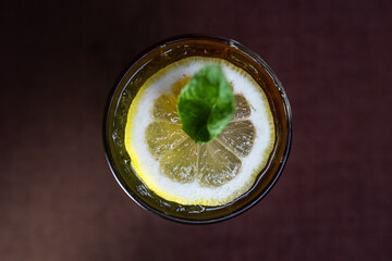 alcoholic drink with coca-Cola and a slice of lemon in a glass
