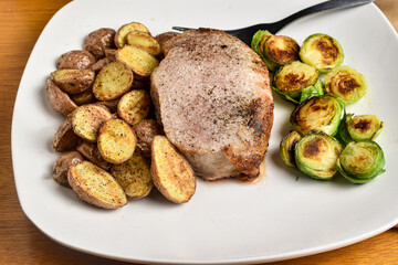 boneless pock chop  with sauteed brussel sprouts and potatoes