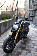 Fototapeta na wymiar a sporty black and yellow motorcycle is street