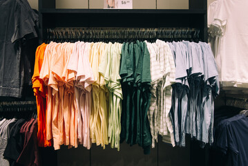 Wide color range of t-shirts hanging on the rack