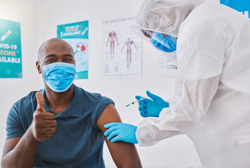 Thumbs up, vaccine and covid injection on a mans arm with him wearing a mask to stay safe. Doctors...