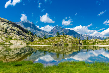 Naklejka na ściany i meble Reflection of the Mount Avic Lake, Aosta Valley, Italy