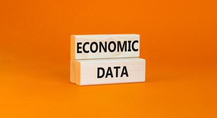 Economic data symbol. Concept words Economic data on wooden block. Beautiful orange table orange background. Business economic data concept. Copy space.