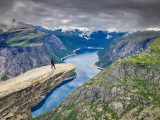 Hiker on the top of Trolltunga scenic spot , Norway