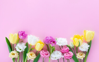 Beautiful spring flowers on pastel pink table. Floral composition for Mothers day.