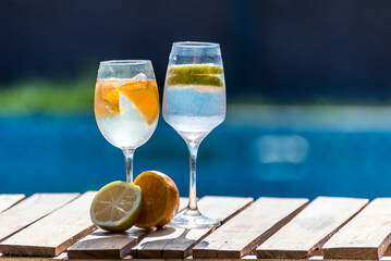 Two glasses of water with a lemon on the side