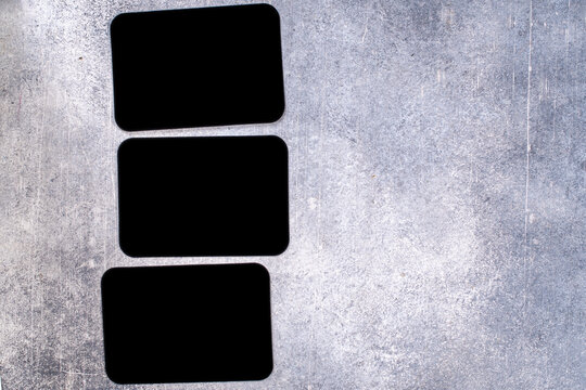 Mockup of three black cards on a grunge background