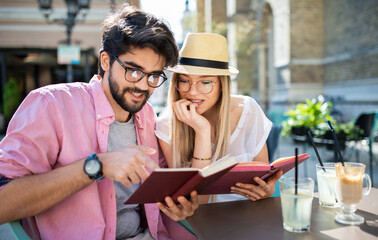 Campus life. Young students learning in the cafe and preparing for the test. Education, relationships, love concept