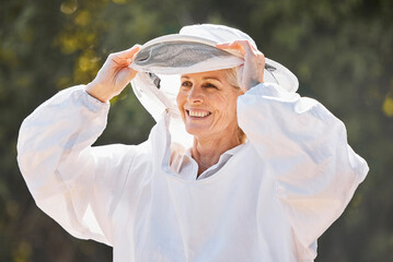 Beekeeper, safety suit and senior farm worker woman ready for honey, bee and produce production....