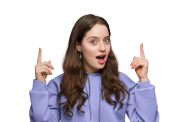 A young and surprised woman with long hair and blue eyes points upward. The girl is wearing a violet oversized hoodie.