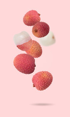 Isolated exotic fruit. Lychee fruits falling down with clipping path as package design element. Full depth of field. Food levitation concept. Fresh fruits.