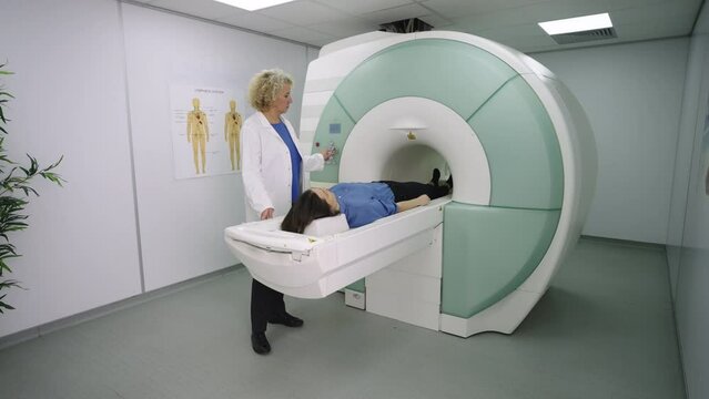 Patient having MRI scanning procedure in modern clinic lying on scanner table in tube. Advance medical concept