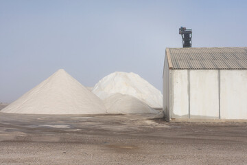 Salt refinery factory. Piles of salt. Foggy day. 