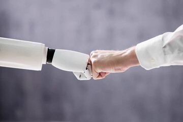 Robot And Human Hand Making Fist Bump
