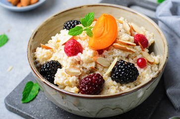 Spelt Porridge with Fruits, Berries, and Nut Topping, Healthy Breakfast or Snack