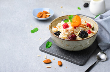 Spelt Porridge with Fruits, Berries, and Nut Topping, Healthy Breakfast or Snack