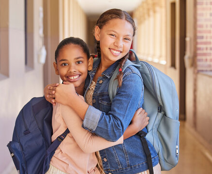 Children, School And Backpack On Happy Students Or Friends Excited About Learning, Education And Making Friends. Portrait Of Girl Kids Together Diversity, Knowledge And Development In Hallway