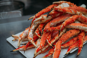 Legs of fresh red Kamchatka crab on the table in the restaurant kitchen. Freshly frozen crab meat for cooking