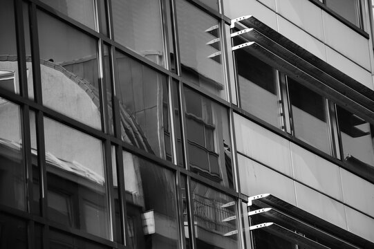 Reflection in windows of modern building. Black white urban abstract photography
