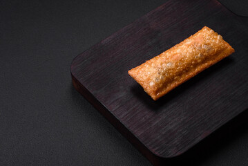 Delicious fresh crispy pie with cherry jam on a wooden cutting board