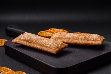 Delicious fresh crispy pie with cherry jam on a wooden cutting board