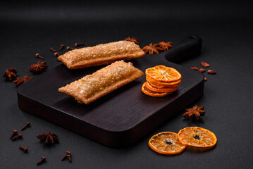 Delicious fresh crispy pie with cherry jam on a wooden cutting board
