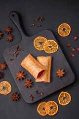 Delicious fresh crispy pie with cherry jam on a wooden cutting board