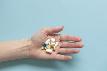 Hands of woman holding pills. Seasonal affective disorder concept