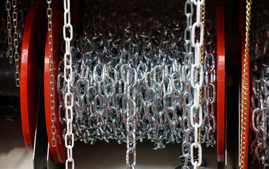 Silver metal chains wound on a reel and displayed for sale