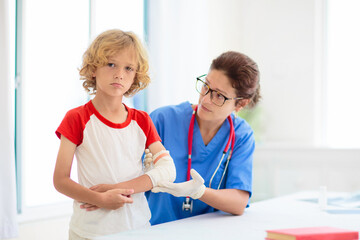 Child with arm injury. Kid with cast at clinic.
