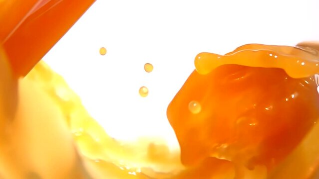 Appetizing orange juice swirling into a wave