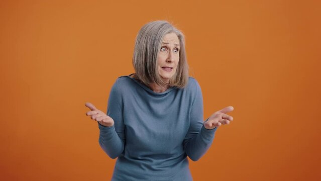 Annoyed woman shouts questioningly waving clenched fists