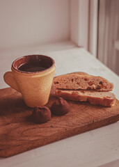 Edible cup made of cookies. Coffee with pastries. Coffee time. Matte image of food and drink. Shtolen and chocolate truffle.