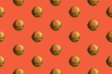 Fast food pattern with burgers on an orange background. Promotional food banner wallpaper