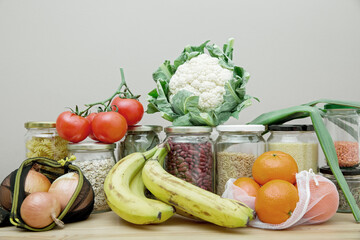Composition of food in reusable packaging, mesh bags and glass jars. The concept of life and shopping without waste. No plastic.