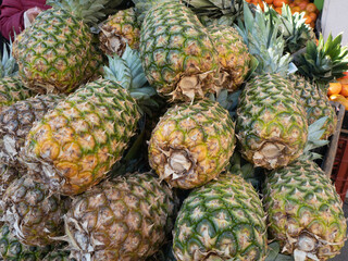 Bulk tropical pineapples for sale in the market