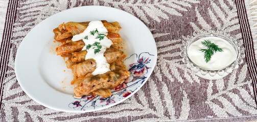 Stuffed cabbage roll with yoghurt sauce and fresh dill, traditional turkish food