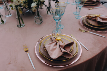 tableware Glasses, flower fork, knife served for dinner in restaurant with cozy interior