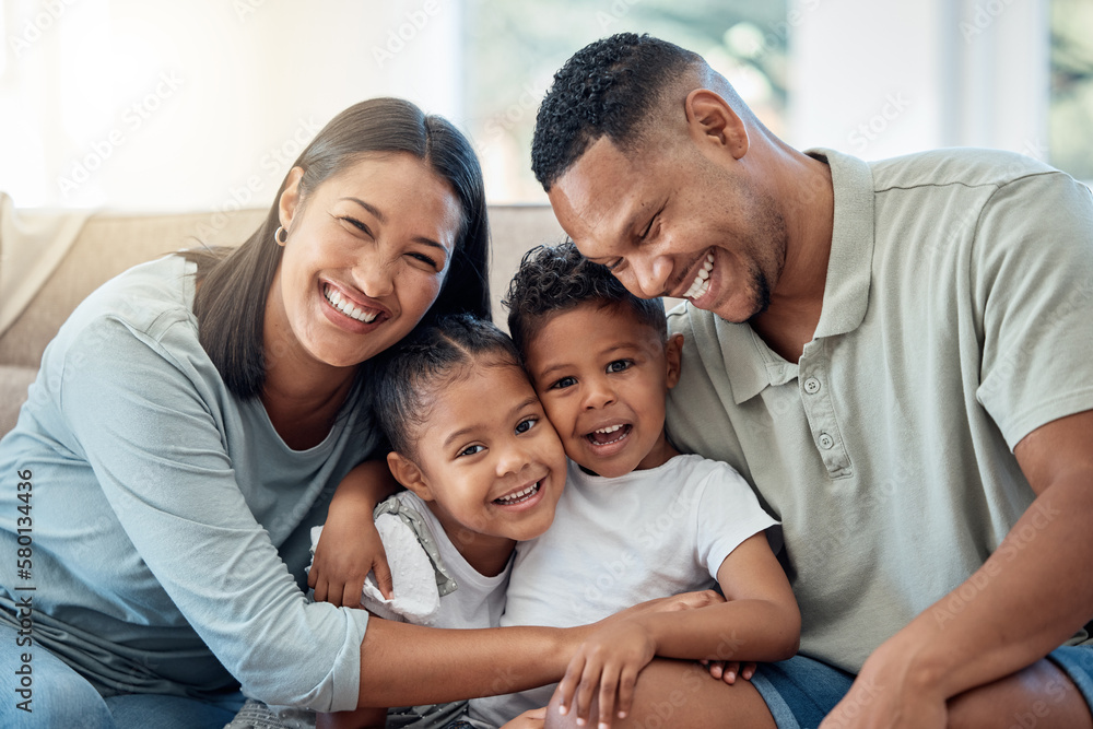 Wall mural Happy, love and family portrait with kids, parents and relax on a sofa with a smile in the living room. Happiness, care and mom with dad sitting and holding children with joy on a couch in home.