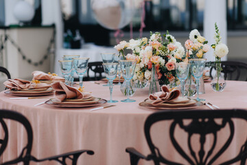 tableware Glasses, flower fork, knife served for dinner in restaurant with cozy interior