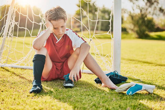Sports, football loss and child sad over fitness game defeat, training competition fail or athlete contest. Kid depression, mental health problem and youth player depressed from soccer field bullying