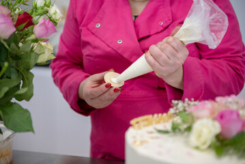 Confectioner decorates a birthday cake