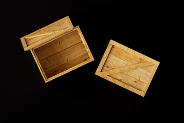 Two pine wooden boxes isolated on a black background. Closed and open boxes. Top view. 3d render