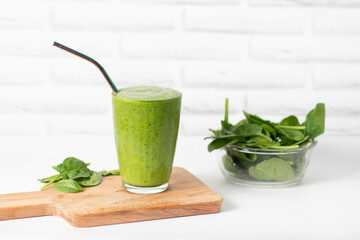 Healthy green smoothie and ingredients on white - spinach, apple and kiwi. detox and healthy food.