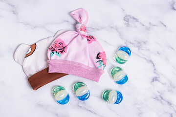 Gel for washing in capsules. Laundry detergent and hats for newborn. Washing children's clothes